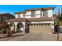 Two-story house with tan exterior, arched entry, and basketball hoop at 904 E Zesta Ln, Gilbert, AZ 85297