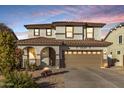 Two-story house with a large driveway and landscaped front yard at dusk at 904 E Zesta Ln, Gilbert, AZ 85297