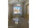 Bright dining room with large window and elegant chandelier at 917 E Betsy Ln, Gilbert, AZ 85296