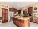 Kitchen boasts granite island and stainless steel appliances at 9345 E Hobart St, Mesa, AZ 85207