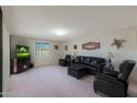 Living room with leather furniture and a fireplace at 9719 W Pineridge Dr, Sun City, AZ 85351