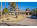 House with a carport and lawn in front at 1019 E Belmont Ave, Phoenix, AZ 85020