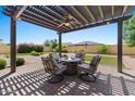 Covered patio with fire pit and seating area, perfect for outdoor entertaining at 10315 E Palladium Dr, Mesa, AZ 85212