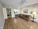 Bright living room with wood floors, and access to kitchen at 10330 W Thunderbird Blvd # A204, Sun City, AZ 85351