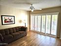 Living room with hardwood floors and sliding glass doors at 10330 W Thunderbird Blvd # A204, Sun City, AZ 85351