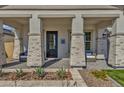 Front porch with brick columns and wicker chairs at 1115 E Gleneagle St, Chandler, AZ 85249