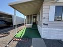 Mobile home entry with covered porch and artificial turf at 11411 N 91St Ave # 221, Peoria, AZ 85345