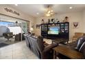 Spacious living room with leather furniture and access to a patio at 13606 N 108Th Dr, Sun City, AZ 85351