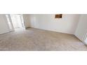 Carpeted living room featuring a patio door and window at 143 N 88Th Pl, Mesa, AZ 85207