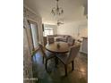 Open concept dining area with a round wooden table and four chairs at 15095 N Thompson Peak Pkwy # 1047, Scottsdale, AZ 85260