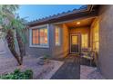 Inviting front entry with a covered porch and seating area at 16169 W Fairmount Ave, Goodyear, AZ 85395