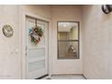 Front entrance with a wreath and a sidelight window offering natural light at 1920 E Maryland Ave # 21, Phoenix, AZ 85016