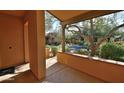 Covered patio overlooking a courtyard with trees and a pool at 20704 N 90Th Pl # 1008, Scottsdale, AZ 85255