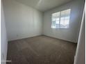 Neutral bedroom featuring carpeted floors, a window, and light-colored walls at 22852 E Lords Way, Queen Creek, AZ 85142