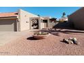 Light-colored stucco house with a large, decorative pot and gravel at 25417 S Kansas Ave, Sun Lakes, AZ 85248