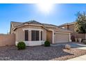 One story home with tan exterior and a two car garage at 25583 W Beth Dr, Buckeye, AZ 85326