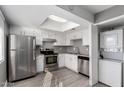 Renovated kitchen with stainless steel appliances and in-unit laundry at 2847 N 46Th Ave # 8, Phoenix, AZ 85035