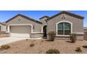 Gray house with a two-car garage and front yard landscaping at 3317 N 300Th Dr, Buckeye, AZ 85396