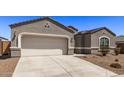 Gray stucco house with a two-car garage and small front yard at 3317 N 300Th Dr, Buckeye, AZ 85396