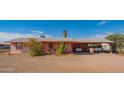 Pink ranch home with carport and desert landscaping at 3616 S 67Th Ave, Phoenix, AZ 85043