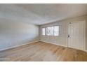 Light-filled living room with hardwood floors and neutral walls at 3810 N Maryvale Pkwy # 1060, Phoenix, AZ 85031