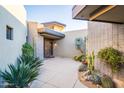 Inviting entry courtyard with native plants and stone pathway to the front door at 39565 N 107Th Way, Scottsdale, AZ 85262