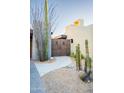 View of a unique wooden gate and desert landscape at 39565 N 107Th Way, Scottsdale, AZ 85262