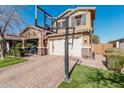 Two-story house with a large front yard, basketball hoop, and two-car garage at 4058 E Mesquite St, Gilbert, AZ 85296