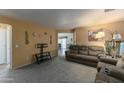 Living room with brown couches and carpeting at 46166 W Sheridan Rd, Maricopa, AZ 85139