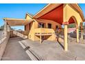 Front view of a yellow house with a red awning and a driveway at 4626 S 8Th St, Phoenix, AZ 85040