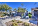 Single story home with neutral exterior, two-car garage, and landscaped front yard at 5015 S Quantum Way, Mesa, AZ 85212