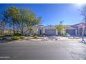 Single story home with neutral exterior, two-car garage, and landscaped front yard at 5015 S Quantum Way, Mesa, AZ 85212