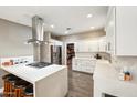 Modern kitchen with white cabinets, stainless steel appliances, and an island at 5028 N Scottsdale Rd, Paradise Valley, AZ 85253