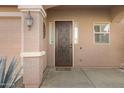 Attractive front door with a decorative iron insert and sidelights at 5415 W Pontiac Dr, Glendale, AZ 85308