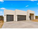 Two-car garage, neutral color home with clean lines and landscaping at 744 E Desert Ln, Phoenix, AZ 85042