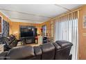 Spacious living room with black leather sectional and fireplace at 7807 E Main St # B-15, Mesa, AZ 85207