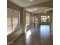 Open concept living area with tile floors and access to backyard at 8605 W Paradise Dr, Peoria, AZ 85345