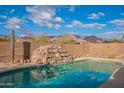 Relaxing pool with waterfall feature and mountain views at 10512 E Dutchmans Trl, Gold Canyon, AZ 85118