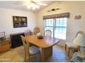 Dining area with wood table and chairs, and a large window at 106 S 72Nd Way, Mesa, AZ 85208