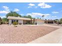 Single-story home with a two-car garage featuring desert landscaping for low maintenance at 11802 S Half Moon Dr, Phoenix, AZ 85044