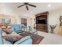 Bright and spacious living room with a ceiling fan, tile floors, and a view of the dining area at 11802 S Half Moon Dr, Phoenix, AZ 85044