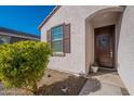 Inviting front entrance with dark brown door and landscaping at 12246 E Pivot Peak E --, Gold Canyon, AZ 85118