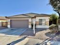 Single story home with garage and landscaping at 12367 W Woodland Ave, Avondale, AZ 85323