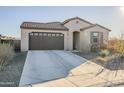 Tan house with a brown garage door and desert landscaping at 12474 E Soloman Rd, Gold Canyon, AZ 85118