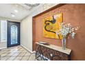 Elegant entry with tile flooring and modern art accents at 12975 W Andrew Ln, Peoria, AZ 85383