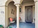 Front entry with arched entryway, iron door, and seating area at 12975 W Andrew Ln, Peoria, AZ 85383