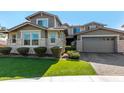 Two-story house with stone accents and a two-car garage at 13713 W Harvest Ave, Litchfield Park, AZ 85340