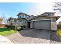 Two-story house with stone accents and a two-car garage at 13713 W Harvest Ave, Litchfield Park, AZ 85340