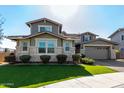 Two-story house with stone accents and a two-car garage at 13713 W Harvest Ave, Litchfield Park, AZ 85340