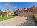 Tan colored stucco home with a two car garage and grassy yard at 14413 N 91St St, Scottsdale, AZ 85260